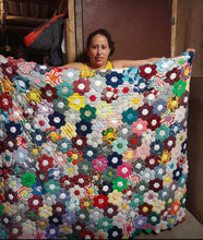 Load image into Gallery viewer, Woman holding colorful handmade hexagon quilt